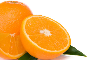 oranges and green leaves  isolated on white