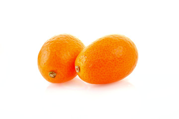 two kumquates  isolated on white