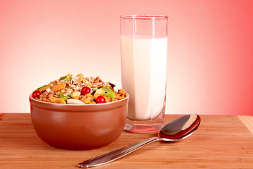 Muesli and milk on red background