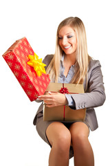 Blond caucasian woman in formal dress with gift boxes isolated