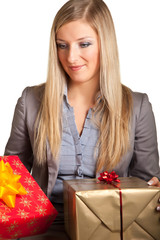 Blond caucasian woman in formal dress with gift boxes isolated