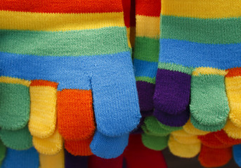 Knitted striped winter gloves in bright colors