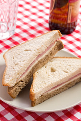 ham sandwich on checkered tablecloth