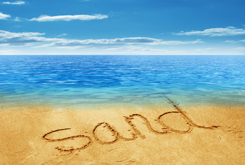 sand handwritten in sand on a beach