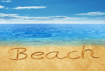 Beach handwritten in sand on a beach