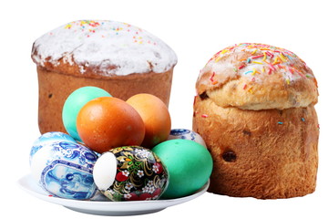 Multi-colored eggs on a plate and cakes. Easter holiday. Isolate