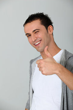 Closeup of young man with thumbs up