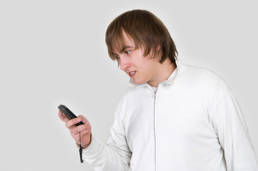 portrait of a unhappy young man with the phone in hand