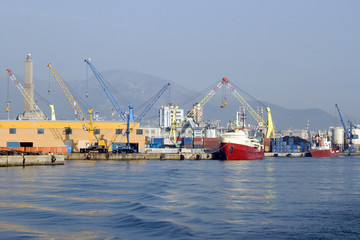 Naklejka premium Boat in Genoa Harbor, Italy