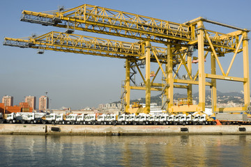 Fototapeta na wymiar Portu w Genui - Container Terminal i wiersz nowych samochodów ciężarowych - Włochy
