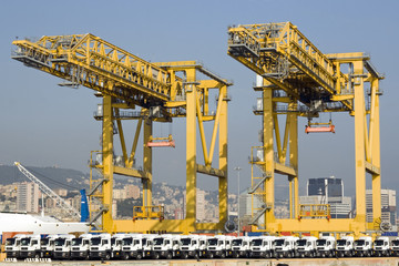 Fototapeta na wymiar Harbor cranes and new trucks - Genoa, Italy