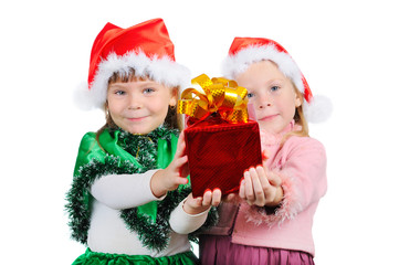 Two girls in the Christmas dress stretch a gift