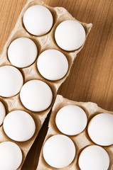 Many white eggs on the wooden table