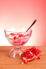 some coctail with pomegranate in glass with spoon