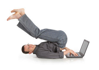 flexible cheerful guy with the laptop isolated on a white backgr