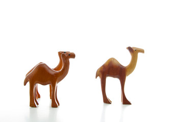 Three wooden camels isolated on a white background