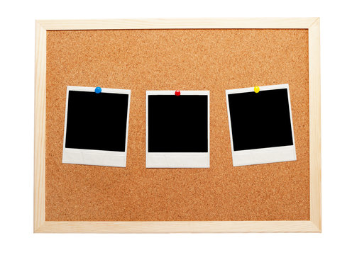 Blank Instant Photos On A Corkboard