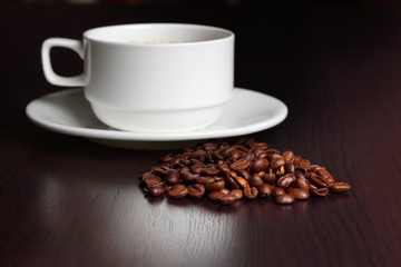cup with coffee and coffee beans