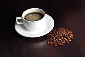 cup with coffee and coffee beans