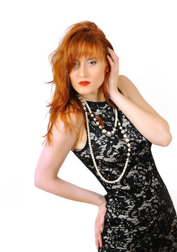Beautiful red haired woman in lace black dress and red lips. iso