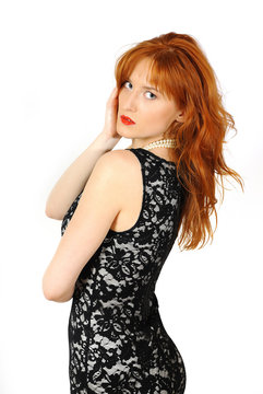 Beautiful red haired woman in lace black dress and red lips. iso
