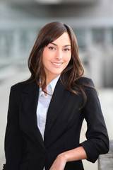 Closeup of beautiful businesswoman standing outside the office