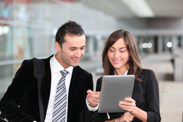 Business people meeting outside with electronic tablet