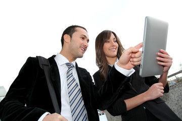 Business people meeting outside with electronic tablet