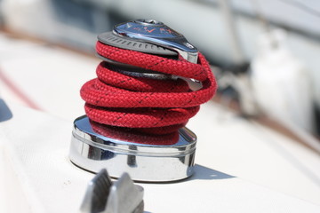 Winch and red rope on a sailboat