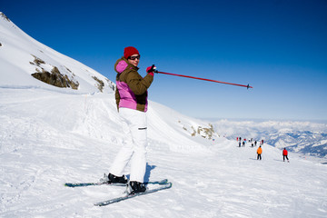 Woman skier pointing ski slope