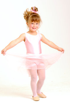 Little Smiley Girl Wearing A Pink Ballet Outfit Dancing