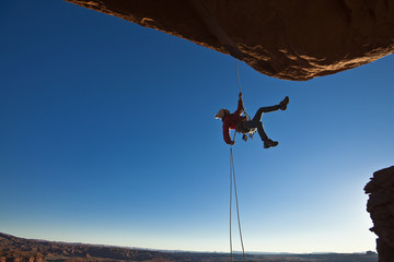 Rock climber rappelling.