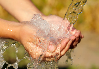 Fototapeta premium Woman's hands with water splash
