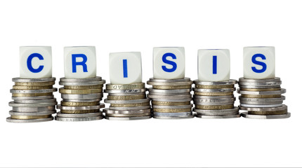 Stacks of coins with the word CRISIS isolated on white
