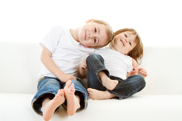 Obraz na płótnie Canvas Boy and girl on sofa