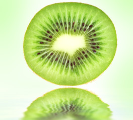 Kiwi closeup on green background