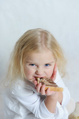 A little girl eating a delicious chocolate