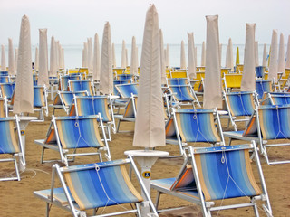 chairs and beach beds closed waiting for tourists