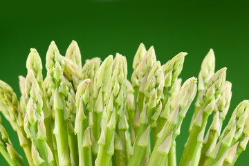Sheaf of asparagus on a green background.