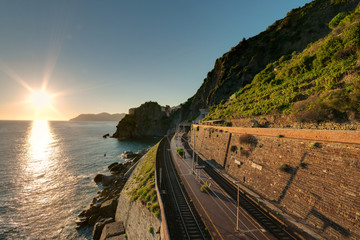 Railway station near the sea and mountains during the sunset