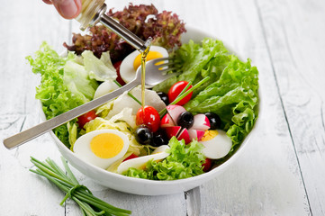 olive oil over mixed salad