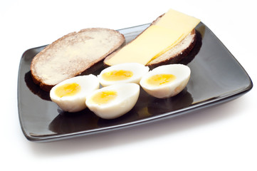 eggs and bread with butter and cheese on white