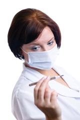 Nurse looks at thermometer