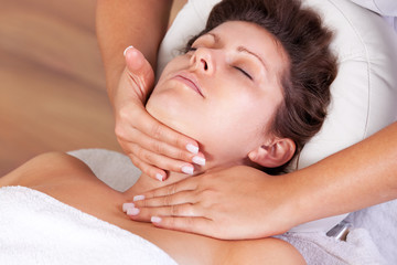 Fototapeta na wymiar Young beautiful woman getting facial massage