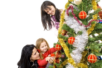 Fototapeta na wymiar Three young happy women decorating the Christmas tree