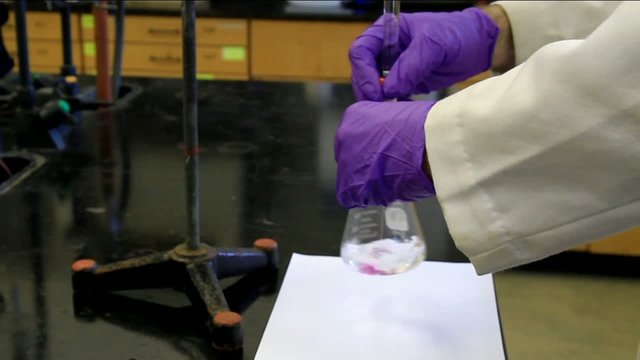 Chemist showing a titration.