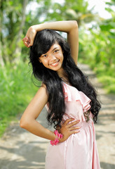 Naklejka premium Portrait of Young happy girl smiling in green nature