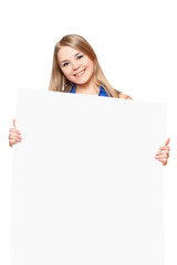 Joyful young woman posing with white board