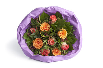 Bouquet of pink and orange roses wrapped in paper