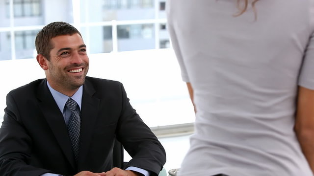 Woman leaving an interview with a businessman